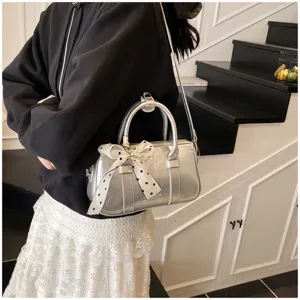 Silver metallic small square shoulder bag with cute polka dot ribbon bow detail for women