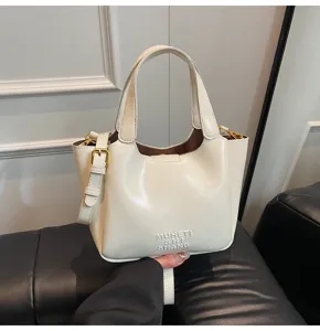 Retro Eimer Tasche Detail, stilvolle Damen Umhängetasche in Beige mit Metallverschluss.