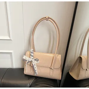 French niche patent leather shoulder bag for women, stylish handbag with bow ribbon detail.