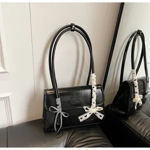 French niche black shoulder bag for women, stylish leather handbag with lace bow detail.