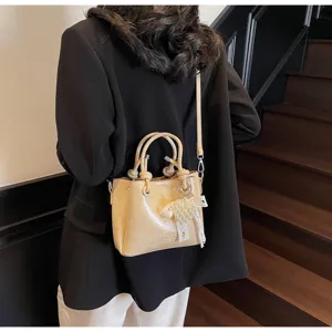 Chic bucket bag with knot handle and pearl bow detail, versatile single shoulder crossbody.