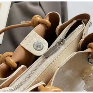Chic minimalist bucket bag detail, premium contrast design handbag with secure zipper.