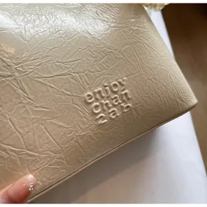 Detail view of the 2025 new minimalist solid color tote bucket bag in chic textured leather.