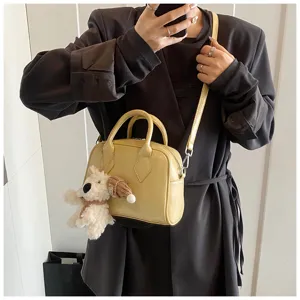 Soft leather bowling bag for women, stylish casual crossbody handbag featuring a cute puppy pendant.