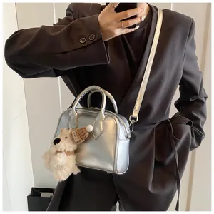 Silver soft leather bowling bag detail, casual fashion shoulder crossbody bag for modern women.