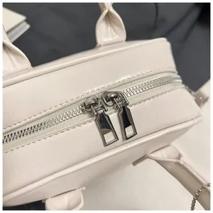 Close-up detail of soft leather bowling bag zipper, smooth metallic hardware and chic handle.