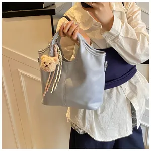 Graue weiche Leder Henkeltasche Detail mit süßem Bär Anhänger für Damen und Alltag.