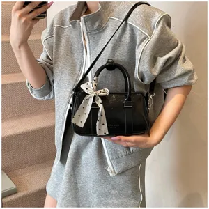 Retro black patent leather handbag with polka dot scarf, stylish crossbody bag for women.