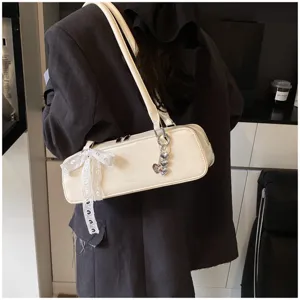 White patent leather baguette shoulder bag with cute bow and heart charm for women stylish