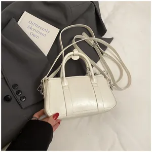 Minimalist white top handle shoulder bag for women, chic commuter crossbody bag daily use.