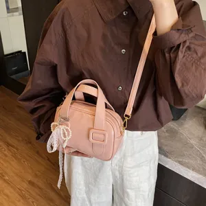 Stylish pink patent leather shoulder handbag, casual versatile crossbody pillow bag for women.