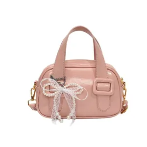 Pink soft leather shoulder handbag for women, sweet pillow bag with pearl bow, main view.