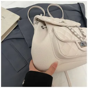 Détail de mini sac à dos matelassé, élégant sac à dos femme en cuir PU beige chic.