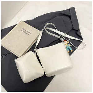 Detail view of a stylish white bucket bag set with shoulder strap, casual daily crossbody bag.