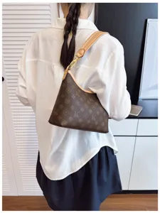 Stylish women's underarm shoulder bag with brown monogram pattern and leather strap.