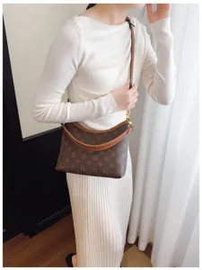 Fashionable brown monogram underarm shoulder bag, stylish daily commuter handbag.