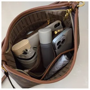 Detailed view of the large capacity shoulder bag interior, showing multi-compartment storage.