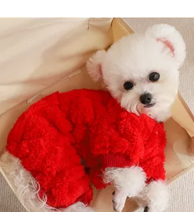 Detailed shot of a cute puppy wearing a warm red fleece four-legged pet winter sweater.