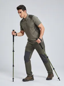 Outdoor trekking pole in action scene, ergonomic grip and secure external lock for hiking.