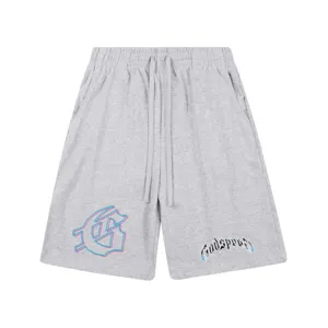 Shorts en coton streetwear gris avec taille élastique à cordon et imprimé graphique.