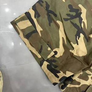 Detailed view of trendy camouflage cargo shorts featuring durable velcro cuff strap design.