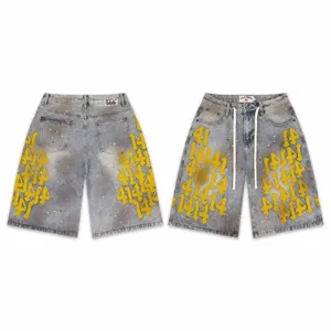 Detailed view of distressed denim shorts with embroidered numbers and stylish paint splatters.
