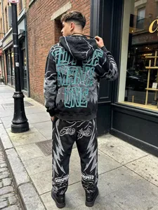 Detailed back view of men's washed black streetwear hoodie and sweatpants set with graphic print.