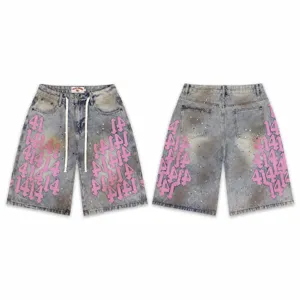 High street washed denim shorts with pink number embroidery and retro paint splatter design.