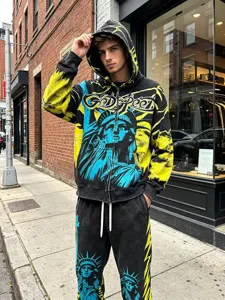 Close-up detail view of the streetwear zip hoodie and sweatpants set with graphic print.