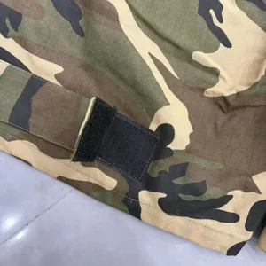 Camo cargo shorts detail featuring durable canvas fabric and practical black velcro strap.