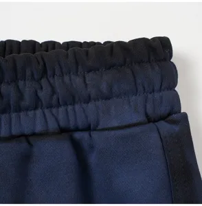 Close-up detail shot of casual shorts elastic waistband with stylish side stripe design.