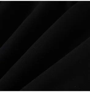 Close-up detail of premium black fabric texture showing soft folds and fine weave quality.