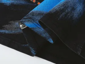 Close-up detail of washed short sleeve t-shirt, showing blue brush print texture and collar label.