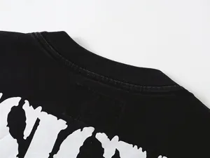 Vintage washed black streetwear t-shirt with distressed white graphic print detail.