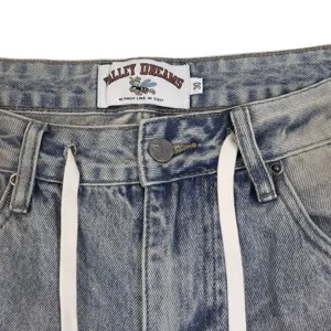 Vintage washed denim shorts detail featuring drawstring waist and custom brand label design.