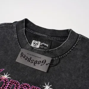 Detailed view of vintage washed long sleeve t-shirt with brand neck label, hang tag, and rhinestones.