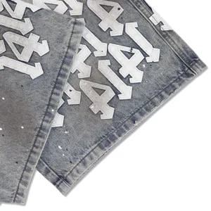 High street washed denim shorts detail with white number appliqué and paint splatters.