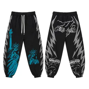 Black high street casual pants with Statue of Liberty print, side lightning stripes, and graphic text.