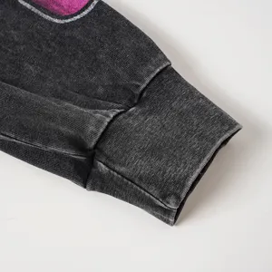Detailed view of the washed distressed long-sleeve t-shirt cuff, showing vintage texture.