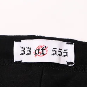 Detailed shot of streetwear apparel garment woven label with gothic number print design.