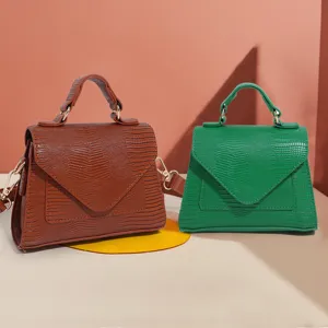 Stylish women's top handle crossbody bag with unique textured pattern, elegant mini square design.