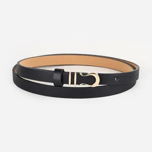 Thin black leather belt close-up, golden metal horseshoe buckle detail, elegant dress accessory.