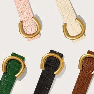 Women wide belt with crocodile pattern texture and vintage gold horseshoe buckle fashion accessory.