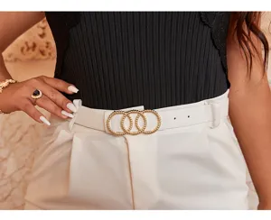 Detail view of a stylish white leather belt with a chic gold beaded ring buckle for women.