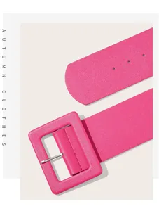 Close-up detail of wide solid color fashion leather belt with matching square buckle.