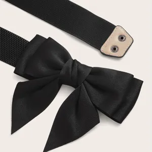 Black elastic waist belt featuring a fabric bow knot, stylish cincher for dresses.