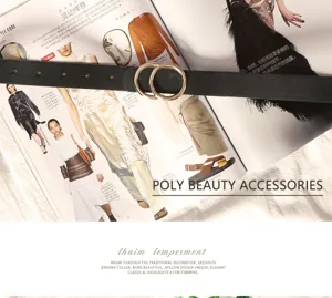 Detail view of the black leather belt with double metal rings on a fashion magazine background.