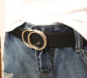 Detailed shot of a classic black leather belt featuring a chic double ring metal buckle.