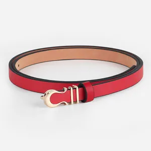 Close-up of red thin leather belt with gold metal horseshoe buckle for dress decoration