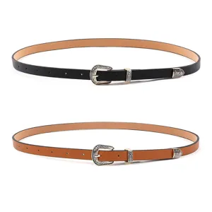 Detailed view of women's vintage PU leather belt with engraved metal buckle and tip. Premium style.